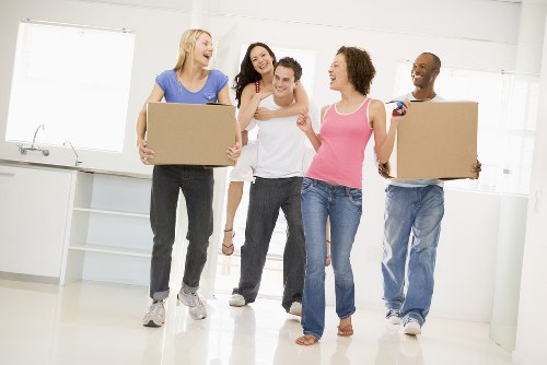 Packing and wrapping household items for a move in West Hampstead