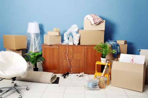 Removal team handling furniture moving in a West Hampstead street
