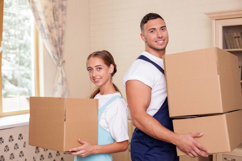 Removal crew handling business equipment during a West Hampstead move